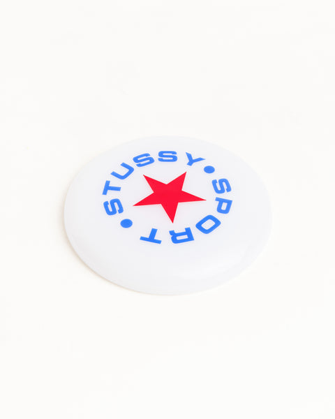 상단에 블루 및 레드 컬러의 로고 아트워크가 프린트된 클리어 색상의 Stüssy Sport Frisbee 액세서리