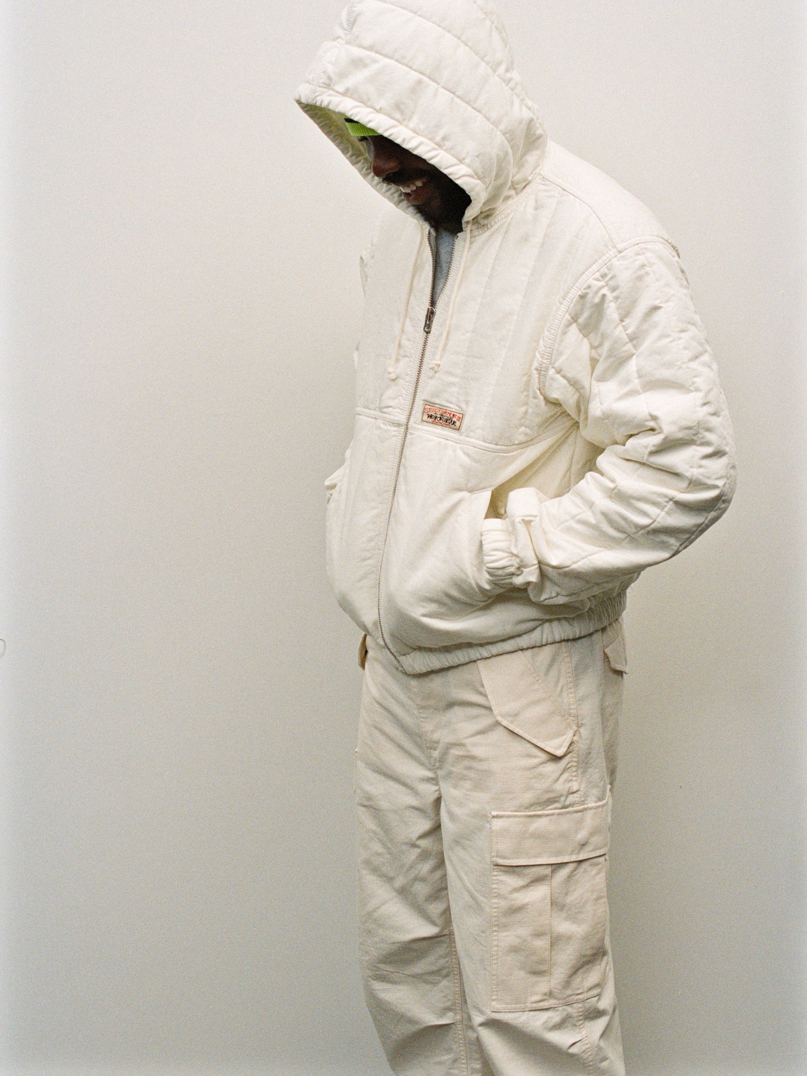 Person wearing the Quilted Canvas Work Jacket in Bone and Cargo Pant in Bone against a plain background.